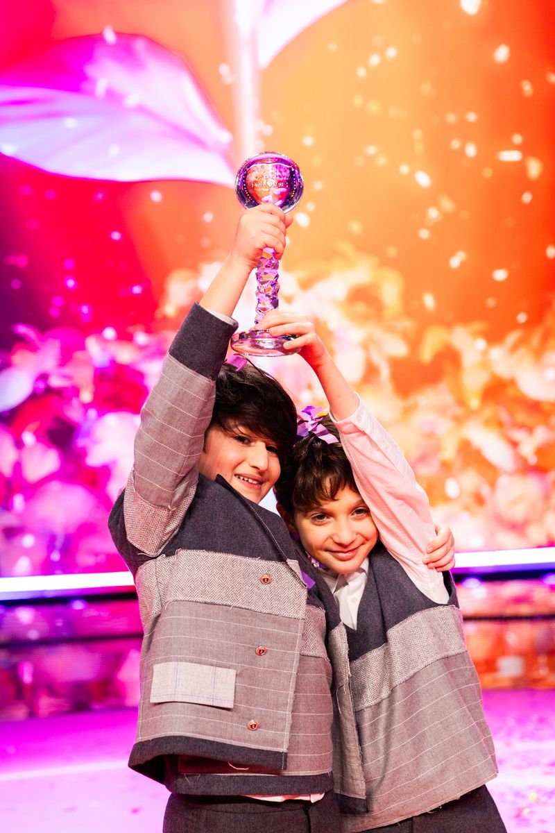 Andria Putkaradze and Gabriel Machabeli hold the trophy after winning Junior Eurovision 2024 for Georgia